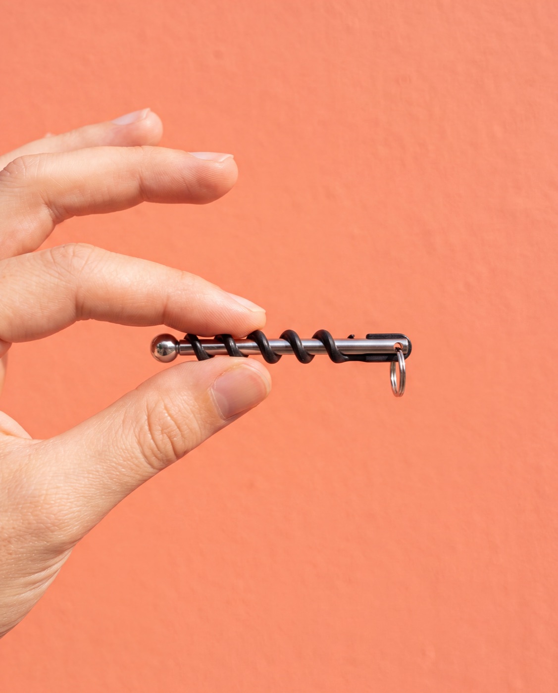 Hand holding the tiny Corklet between two fingers